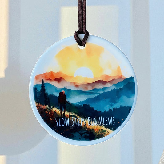 Slow Steps Big Views Ceramic Hanging Ornament – Hiker in Mountains at Sunset | Boho Adventure Home Décor
