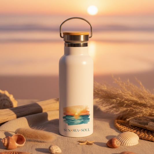 White water bottle with a sunset design and 'Sun Sea Soul' text on a wooden table.