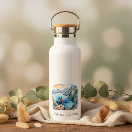 White water bottle with a scenic label on a wooden table with a blurred background