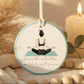 Decorative hanging disc with a meditating figure and text on a light background