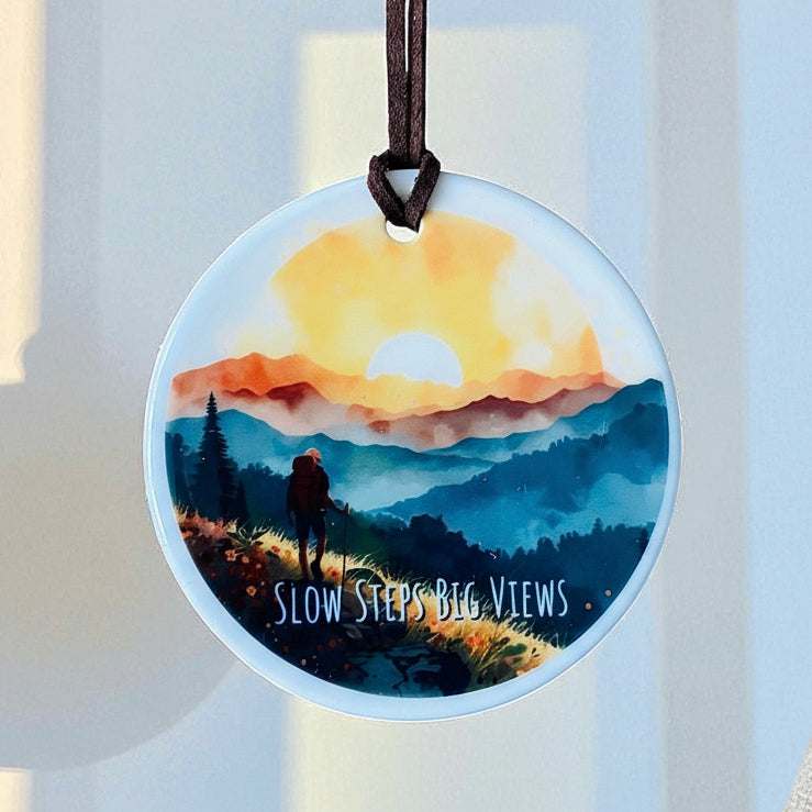 Slow Steps Big Views Ceramic Hanging Ornament – Hiker in Mountains at Sunset | Boho Adventure Home Décor