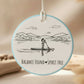 Circular pendant with a design of a person paddleboarding and text 'Balance Found Spirit Free' on a light blue background.