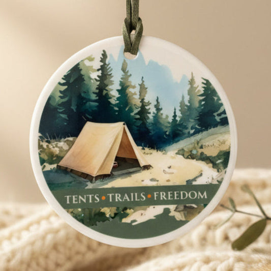 Round decorative hanging with a tent illustration and 'Tents Trails Freedom' text.