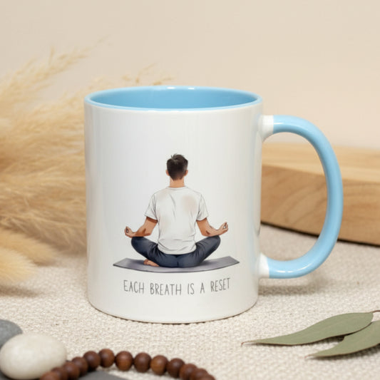 Mug with a person meditating and text 'Each breath is a reset' on a beige background