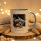 Mug with mountain and tent design and text 'Simple pleasures infinite skies' on a dark background