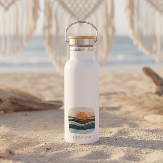 White water bottle with a sunset design on a wooden table with a blurred background