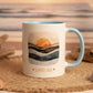 Mug with a sunset design and 'Sunset Soul' text on a white surface.