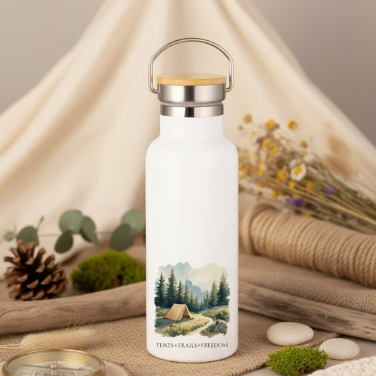 White water bottle with nature design on a wooden surface next to an orange mug.